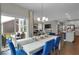 Open-concept dining room with modern chandelier, natural light, and patio access at 19390 Mcbee Ave, Westfield, IN 46074