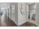 Hallway featuring a decorative accent wall and views into the bathroom and main living area at 19390 Mcbee Ave, Westfield, IN 46074