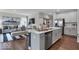 Open-concept kitchen flows into the living area, featuring a large island with modern appliances and seating at 19390 Mcbee Ave, Westfield, IN 46074