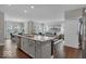 Bright, open-concept kitchen with island, stainless steel appliances, and a view into the dining and living areas at 19390 Mcbee Ave, Westfield, IN 46074