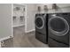 Modern laundry room with sleek washer and dryer, storage shelves, and access to a closet at 19390 Mcbee Ave, Westfield, IN 46074