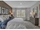 Bright main bedroom featuring a wood accent wall and a serene view from the windows at 19390 Mcbee Ave, Westfield, IN 46074