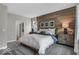 Bright main bedroom featuring a wood accent wall and a view into the bathroom at 19390 Mcbee Ave, Westfield, IN 46074
