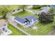 Aerial view of a charming home with an outdoor patio, landscaped backyard, and driveway at 203 Leerkamp Dr, Franklin, IN 46131