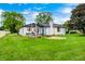 Expansive backyard featuring a patio area, lush lawn, garden bed and a charming home exterior at 203 Leerkamp Dr, Franklin, IN 46131