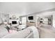 Open living room with fireplace, neutral tones, patio access, and kitchen views at 203 Leerkamp Dr, Franklin, IN 46131