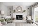 Close up of living room fireplace, chairs, and decor at 203 Leerkamp Dr, Franklin, IN 46131