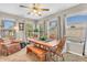 Sunlit dining room boasting a wooden dining table, cozy seating, and multiple windows showcasing the outdoor scenery at 2044 Flamingo Way, Franklin, IN 46131