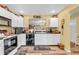 Well-lit kitchen featuring white cabinetry, sleek black countertops, and a stylish mosaic backsplash at 2044 Flamingo Way, Franklin, IN 46131
