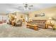 Expansive living room offering a comfortable seating arrangement, soft carpeting, and seamless flow to other spaces at 2044 Flamingo Way, Franklin, IN 46131