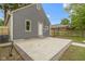 Exterior view of the backyard featuring a patio, gray siding and grassy area at 2046 N Tibbs Ave, Indianapolis, IN 46222