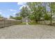 Backyard of the house featuring a gravel area, lawn and fence at 2046 N Tibbs Ave, Indianapolis, IN 46222