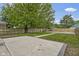 Spacious backyard with a concrete patio, grassy area, gravel space, and a wooden fence for privacy at 2046 N Tibbs Ave, Indianapolis, IN 46222