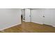 View of the basement with wood flooring and white painted walls leading to a laundry area at 2046 N Tibbs Ave, Indianapolis, IN 46222