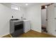 Basement laundry area featuring modern washer and dryer units and a small window at 2046 N Tibbs Ave, Indianapolis, IN 46222