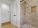 Bathroom featuring a walk-in shower with a recessed shelf and a partial view of the entrance door at 2046 N Tibbs Ave, Indianapolis, IN 46222