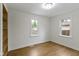 Bedroom featuring laminate floors, built-in shelves and natural light from the windows at 2046 N Tibbs Ave, Indianapolis, IN 46222