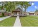 Charming home featuring a red porch and mature trees in a well-maintained yard at 2046 N Tibbs Ave, Indianapolis, IN 46222