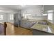 Open kitchen featuring stainless-steel refrigerator, granite countertops, and gas cooktop at 2046 N Tibbs Ave, Indianapolis, IN 46222
