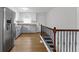 Open concept kitchen with stainless steel refrigerator and view of stairway at 2046 N Tibbs Ave, Indianapolis, IN 46222