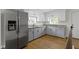 Kitchen features stainless steel fridge, granite countertops, and modern cabinetry at 2046 N Tibbs Ave, Indianapolis, IN 46222