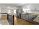 Kitchen area with stairway and stainless-steel fridge, granite countertops and gas cooktop at 2046 N Tibbs Ave, Indianapolis, IN 46222