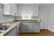 Renovated kitchen featuring modern cabinets, granite countertops and stainless sink at 2046 N Tibbs Ave, Indianapolis, IN 46222