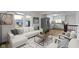 Open living room with a cozy seating area and views of the modern, gray kitchen at 2046 N Tibbs Ave, Indianapolis, IN 46222