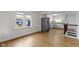 Bright living space features wood floors and a partial view of the stainless steel appliances in kitchen at 2046 N Tibbs Ave, Indianapolis, IN 46222