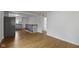 View of the open floorplan, the kitchen is adjacent to the living room with wood floor at 2046 N Tibbs Ave, Indianapolis, IN 46222