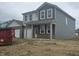 Charming home featuring gray siding, brick accents, and a welcoming front porch at 2287 Oakmont Dr, Plainfield, IN 46168