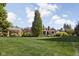 Expansive backyard with well-manicured lawn and charming brick home at 24 Shannon Rd, Zionsville, IN 46077