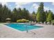 An inviting backyard featuring a sparkling pool, lounge chairs, and lush landscaping provides a serene outdoor retreat at 24 Shannon Rd, Zionsville, IN 46077