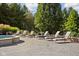 Luxury backyard boasts stone patio, lounge chairs, landscaping, and relaxing jacuzzi at 24 Shannon Rd, Zionsville, IN 46077