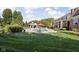 Sprawling backyard with lush lawn, swimming pool, and elegant brick home at 24 Shannon Rd, Zionsville, IN 46077