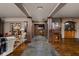 Spacious basement featuring stone accent wall, tile floors, dark wood pillars and a seating area at 24 Shannon Rd, Zionsville, IN 46077