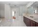 Well lit, spacious bathroom features tile floors, granite counters, and a glass block wall to bring in natural light at 24 Shannon Rd, Zionsville, IN 46077