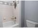 Clean bathroom featuring white tile, a bathtub/shower combo, and neutral walls at 24 Shannon Rd, Zionsville, IN 46077
