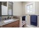 Well-lit bathroom featuring granite countertops, modern fixtures, and a built-in bench with storage at 24 Shannon Rd, Zionsville, IN 46077
