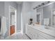 Beautiful bathroom with double vanity, light gray walls, and large mirror with elegant light fixture at 24 Shannon Rd, Zionsville, IN 46077