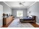 Bright bedroom boasts hardwood floors, neutral gray paint, a ceiling fan, and a large window with views at 24 Shannon Rd, Zionsville, IN 46077