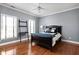 Cozy bedroom features a wood floor, stylish furnishings, and a ceiling fan at 24 Shannon Rd, Zionsville, IN 46077