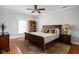 Cozy bedroom with wood floors, a dark wood sleigh bed, a bookcase, and a sunny window with views at 24 Shannon Rd, Zionsville, IN 46077