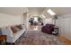 Comfortable bonus room featuring hardwood floors, neutral paint, skylights, couch, work area, and a decorative area rug at 24 Shannon Rd, Zionsville, IN 46077
