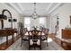 Formal dining room boasts a trey ceiling, hardwood floors, and a classic chandelier at 24 Shannon Rd, Zionsville, IN 46077