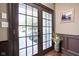 Entryway featuring double glass doors, dark wood trim, and hardwood floors at 24 Shannon Rd, Zionsville, IN 46077