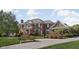 Elegant brick home featuring manicured landscaping and a circular driveway at 24 Shannon Rd, Zionsville, IN 46077