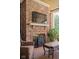 Cozy outdoor brick fireplace with a decorative screen and stone mantel, perfect for entertaining and relaxation at 24 Shannon Rd, Zionsville, IN 46077