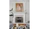 Elegant fireplace with marble surround, complemented by stylish decor and hardwood floors at 24 Shannon Rd, Zionsville, IN 46077
