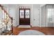Spacious foyer with a beautiful hardwood door, hardwood floors, and modern finishes at 24 Shannon Rd, Zionsville, IN 46077